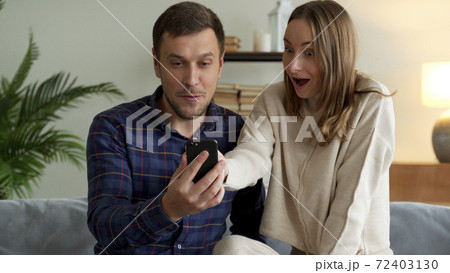 Excited happy family couple looking at digital tablet feel winners overjoyed by lottery winning bet bid, celebrate good internet news. Excited happy family couple looking at digital tablet feel winners overjoyed by lottery winning bet bid, celebrate good internet news. 72403130