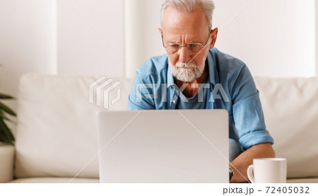 Stylish senior man using laptop. 72405032