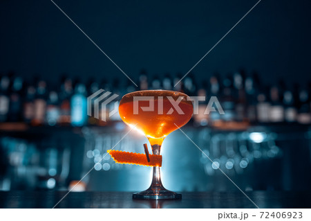 glass of fresh orange cocktail on blue background glass of fresh orange cocktail on blue background 72406923