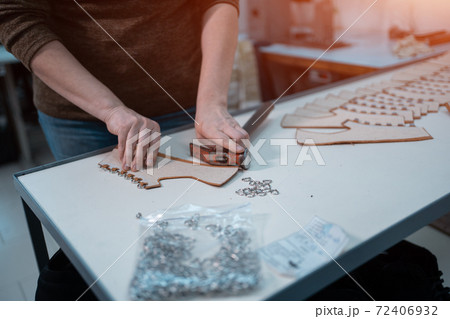 man shaping leather for shoe with knife on factory 72406932