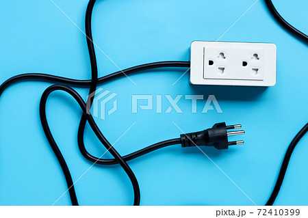 Electrical power strip and plug on blue background. Top view 72410399
