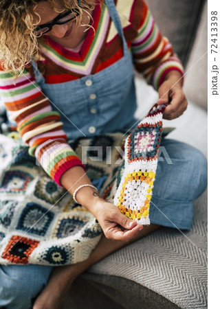 Coloured diy artwork at home with cheerful happy adult woman cut and use coloured wool fabric to create clothes or accessories - colors and hand made home indoor activity Coloured diy artwork at home with cheerful happy adult woman cut and use coloured wool fabric to create clothes or accessories - colors and hand made home indoor activity 72413398
