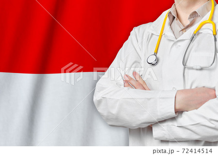 Republic of Indonesia healthcare concept with doctor on flag background. Medical insurance, work or study in the country. Republic of Indonesia healthcare concept with doctor on flag background. Medical insurance, work or study in the country. 72414514