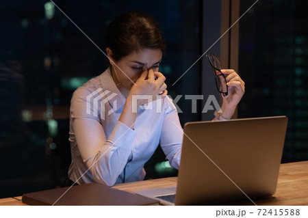 Tired Indian female employee exhausted at workplace Tired Indian female employee exhausted at workplace 72415588