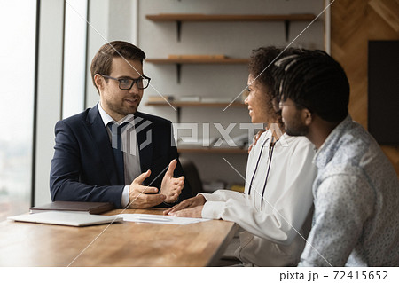 Male realtor consult biracial family at meeting 72415652