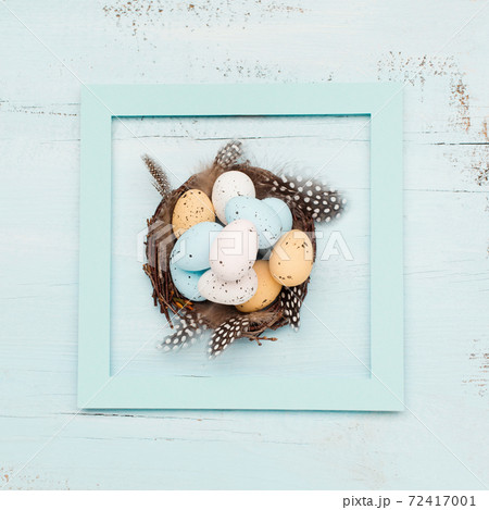 Easter craft eggs and branches on blue pastel background with space for text. Flat lay image composition, top view. Easter craft eggs and branches on blue pastel background with space for text. Flat lay image composition, top view. 72417001