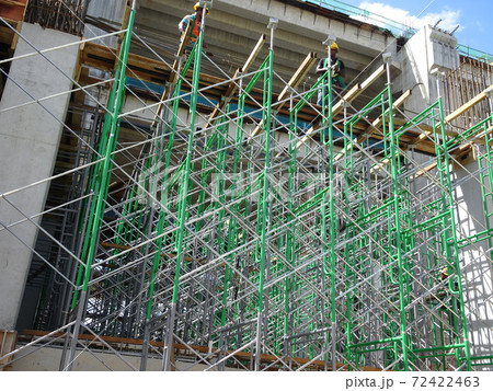 MALACCA, MALAYSIA -MARCH 2, 2020: Construction workers working at height at the construction site. They are supplied with harnesses and other safety equipment to prevent them from having an accident. MALACCA, MALAYSIA -MARCH 2, 2020: Construction workers working at height at the construction site. They are supplied with harnesses and other safety equipment to prevent them from having an accident. 72422463