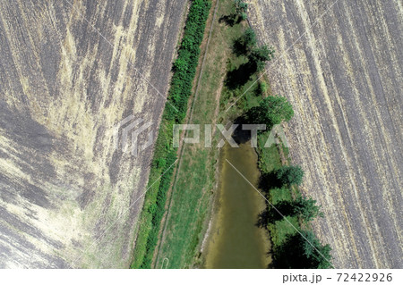 Abstract aerial view of the pointed end of a fishing pond 72422926