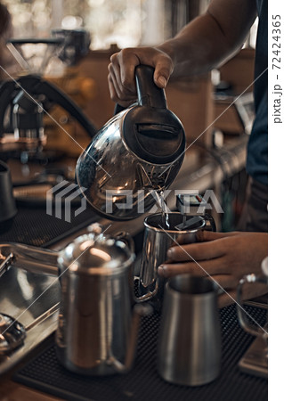 Close up focus on male hand holding kettle 72424365