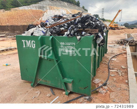 KUALA LUMPUR, MALAYSIA -MARCH 13, 2020: Huge wasted disposal bin used to collect rubbish and unused material from the construction site. Has a fixed collection schedule KUALA LUMPUR, MALAYSIA -MARCH 13, 2020: Huge wasted disposal bin used to collect rubbish and unused material from the construction site. Has a fixed collection schedule 72431989