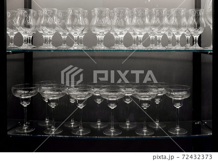 empty clean wine glasses on a glass shelf  72432373