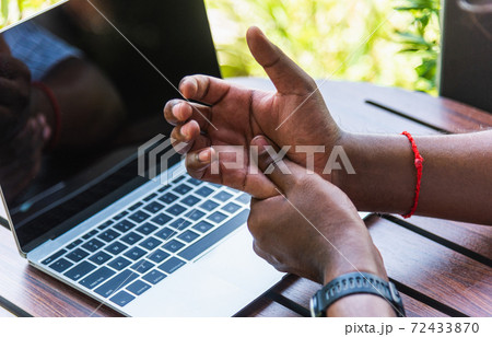 black man holding his wrist pain black man holding his wrist pain 72433870