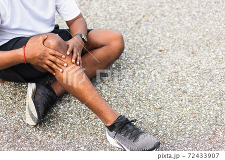 runner black man wear watch sitting he uses hands joint hold on his knee while running runner black man wear watch sitting he uses hands joint hold on his knee while running 72433907