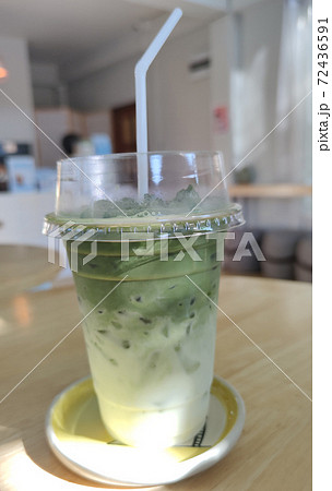 Freshness iced greentea latte with coconut milk, soy milk in disposable take away cup with white Straw, advsertising backgrounds, allergical drinking 72436591