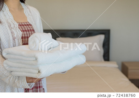 Soft towels on bedroom. 72438760