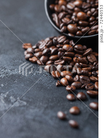Fresh raw organic coffee beans on dark background. 72440553