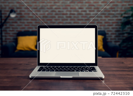 Laptop a blank screen on the table at night for putting on a computer advertisement. Laptop a blank screen on the table at night for putting on a computer advertisement. 72442310