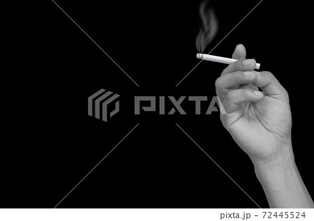 hand holding a cigarette 72445524