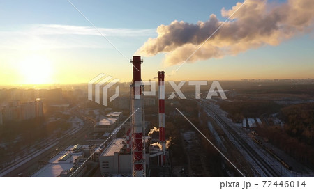 Aerial shot of red and white industrial smoke stacks on sunset background. Moscow, Russia Aerial shot of red and white industrial smoke stacks on sunset background. Moscow, Russia 72446014