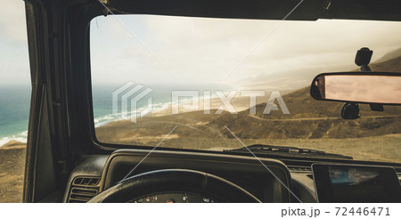 Inside view of car with mobile modern phone gps system to find the road and use maps in off road scenic place with beach and mountains view - concept of adventure and roaming wifi internet everywhere Inside view of car with mobile modern phone gps system to find the road and use maps in off road scenic place with beach and mountains view - concept of adventure and roaming wifi internet everywhere 72446471