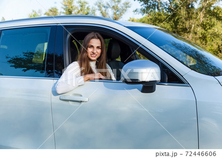 the girl in the car looking out the window 72446606