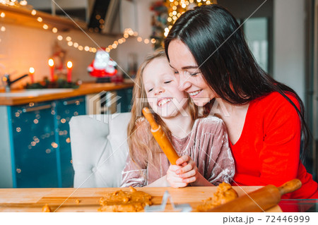 Happy family mother and daughter bake cookies for Christmas 72446999