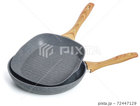 Two cast-iron frying pans with a wooden handle without a lid, on a white background. 72447129