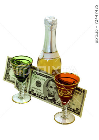 on a white background bottle of wine two glasses and money 72447485