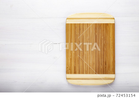 Cutting kitchen board on white wooden table. Space for text. Cutting kitchen board on white wooden table. Space for text. 72453154