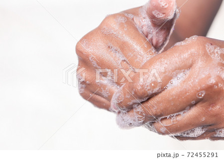 young man washing hands with soap warm water  72455291