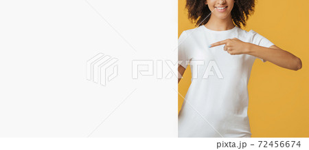 Smiling modern blogger or student offering ad Smiling modern blogger or student offering ad 72456674