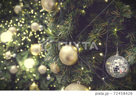 Christmas background of de-focused lights with decorated tree 72458426
