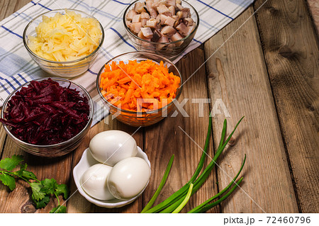 Ingridients for russian salad. Potatoes, carrots, herring, eggs placed on the table. Ready for cooking. Ingridients for russian salad. Potatoes, carrots, herring, eggs placed on the table. Ready for cooking. 72460796