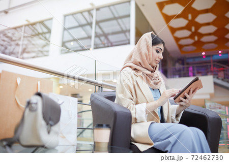 Young Middle-Eastern Woman using Digital Tablet in Mall 72462730