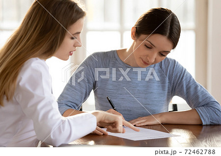 Female patient sign paperwork close deal with doctor Female patient sign paperwork close deal with doctor 72462788