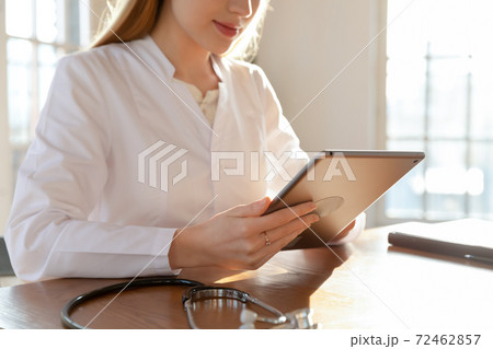 Close up of female doctor use tablet consulting client Close up of female doctor use tablet consulting client 72462857