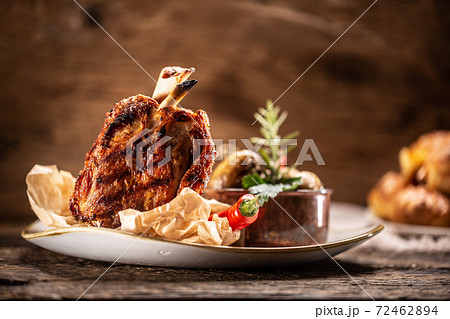 German pork ham hock or Schweinshaxe served in a rustic restaurant German pork ham hock or Schweinshaxe served in a rustic restaurant 72462894