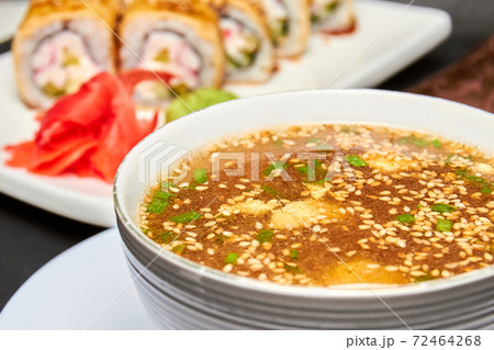 Japanese Miso soup and sushi rolls on the background Japanese Miso soup and sushi rolls on the background 72464268