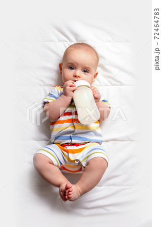 Baby with baby milk bottle. Top view. 72464783