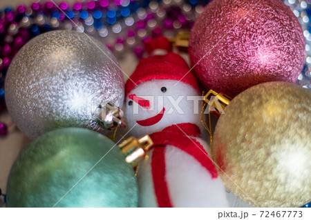 White snowman in a red hat with Christmas balls and beads 72467773