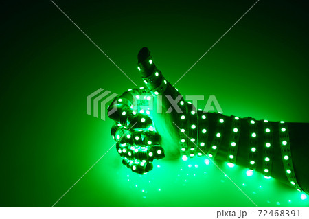 thumbs up hand covered with green led lights, illuminated background thumbs up hand covered with green led lights, illuminated background 72468391