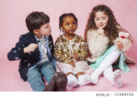 lifestyle people concept: diverse nation children playing together, boy and girl, caucasian and african american lifestyle people concept: diverse nation children playing together, boy and girl, caucasian and african american 72468438