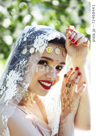 young pretty indian girl in jewelry and veil posing cheerful happy smiling in green park, lifestyle people concept young pretty indian girl in jewelry and veil posing cheerful happy smiling in green park, lifestyle people concept 72468441