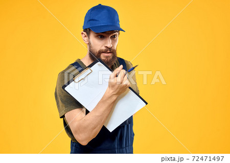 Man in working form documents transportation delivery service yellow background 72471497