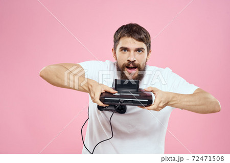 Man with prefix in hand joystick games lifestyle fun pink background white t-shirt 72471508