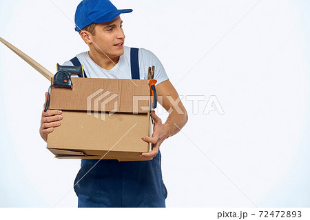 A man in a working uniform with a box in his hand loading a delivery service 72472893
