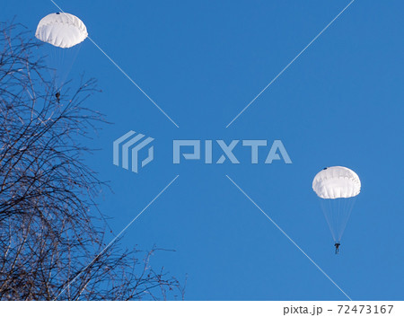 Couple of skydivers flying in bright blue sky 72473167