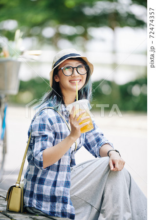 Woman drinking refreshing cocktail Woman drinking refreshing cocktail 72474357