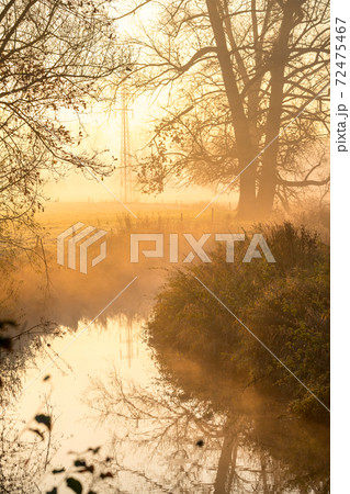 at sunrise whit mist 72475467