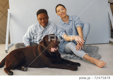 International couple on a blue background with a dog 72475879